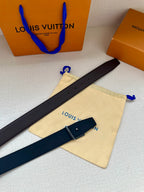 Louis Vuitton belt laid out flat with dark leather strap, LV buckle, and tag