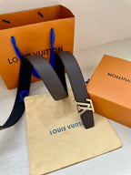 Louis Vuitton belt with dark leather straps and large silver-tone LV logo buckle