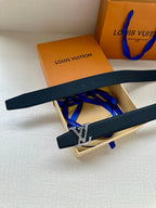 Dark blue leather belt with gold LV buckle, shown laid diagonally over box.
