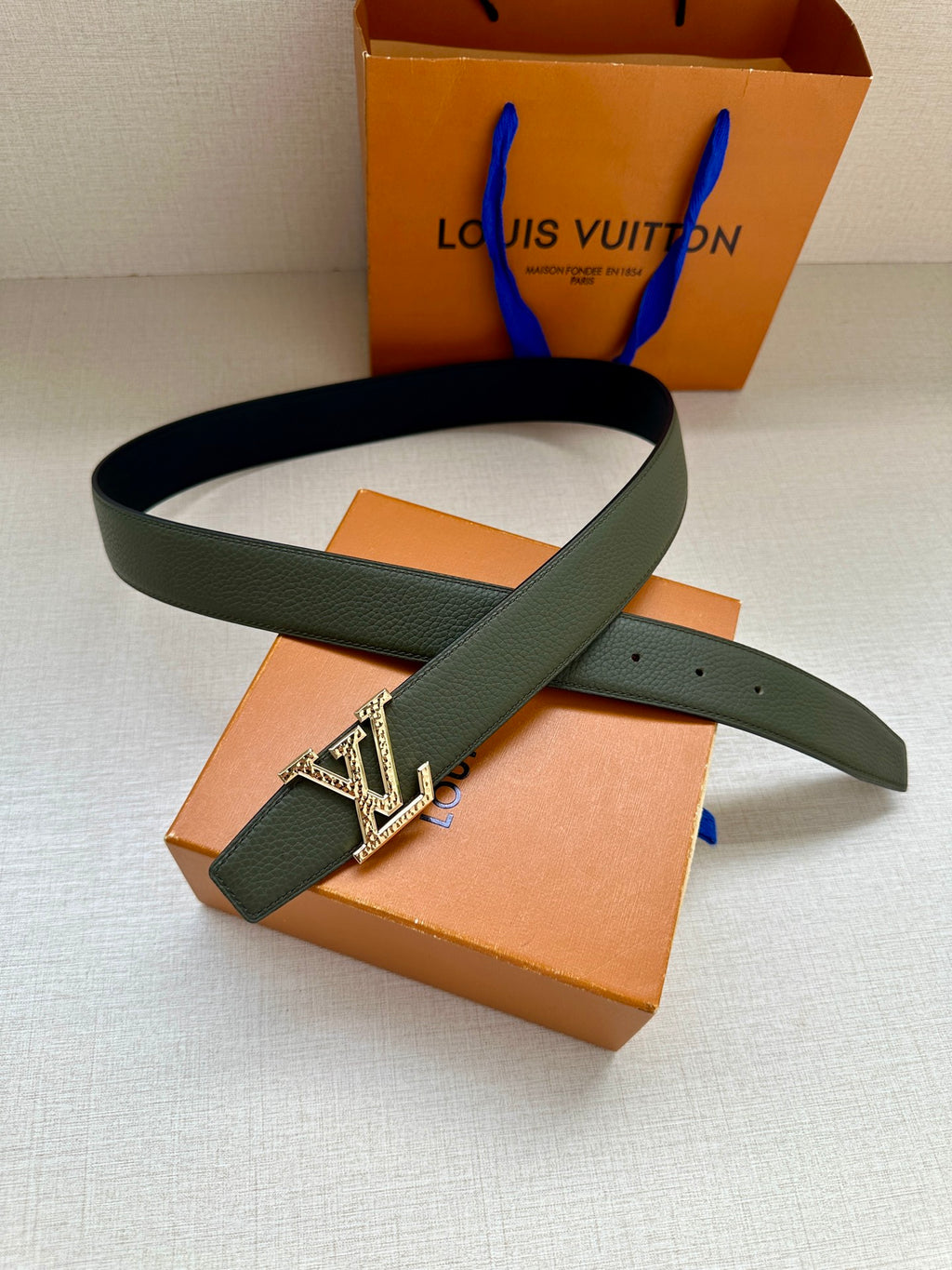 Dark green leather belt with silver LV buckle on strap