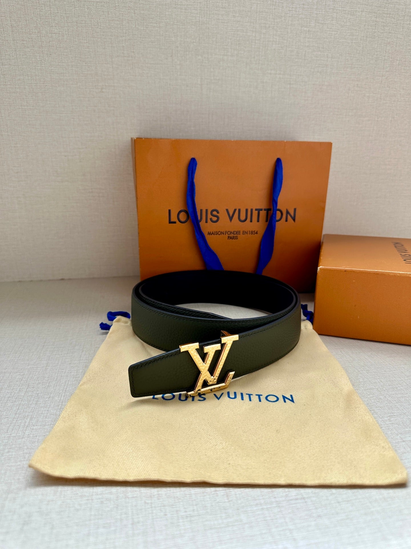 Dark green leather belt with silver LV buckle and loop strap