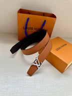 Louis Vuitton leather belt, tan strap with silver LV buckle and dark reverse