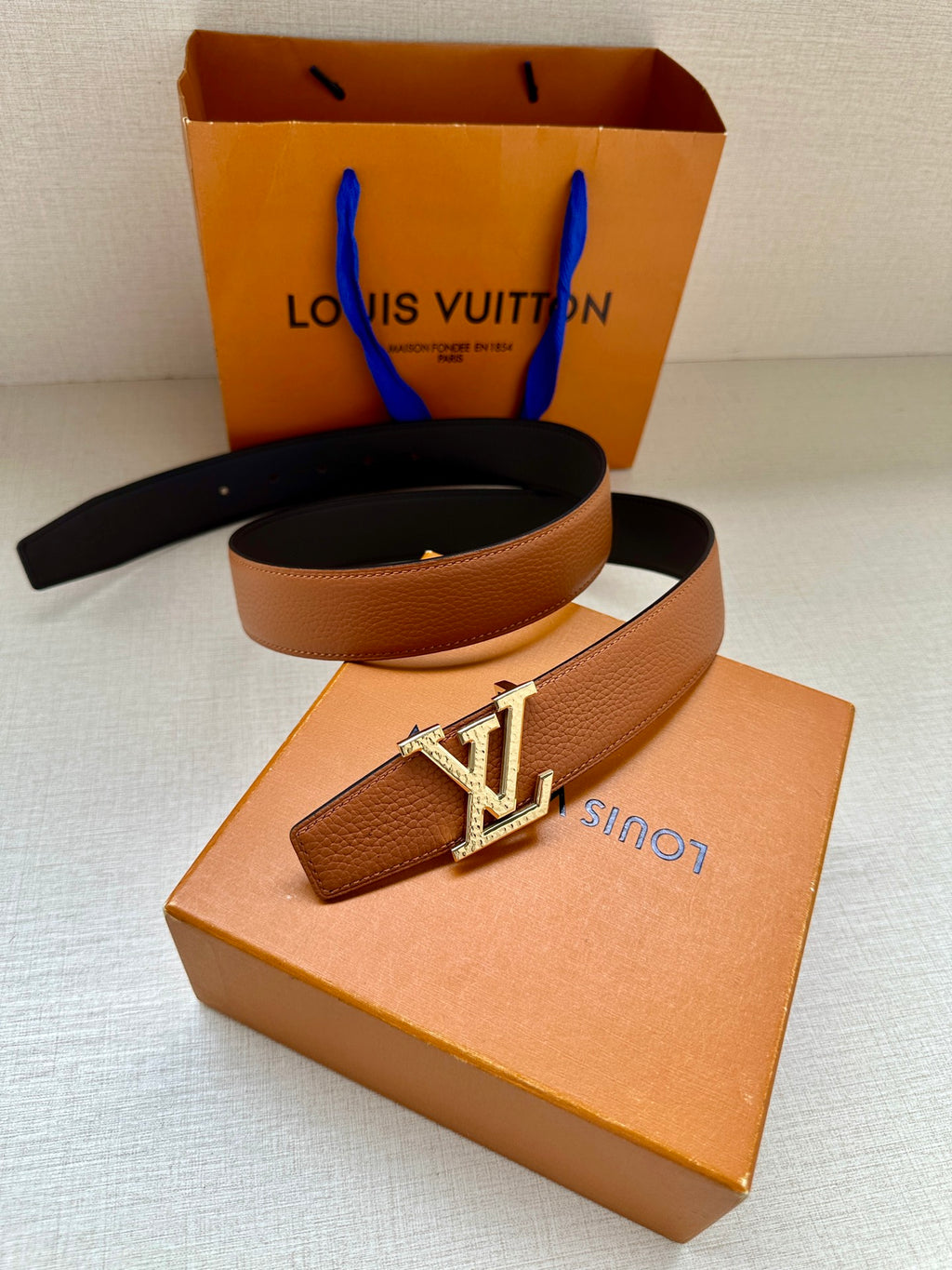 Louis Vuitton leather belt, tan strap with gold LV buckle