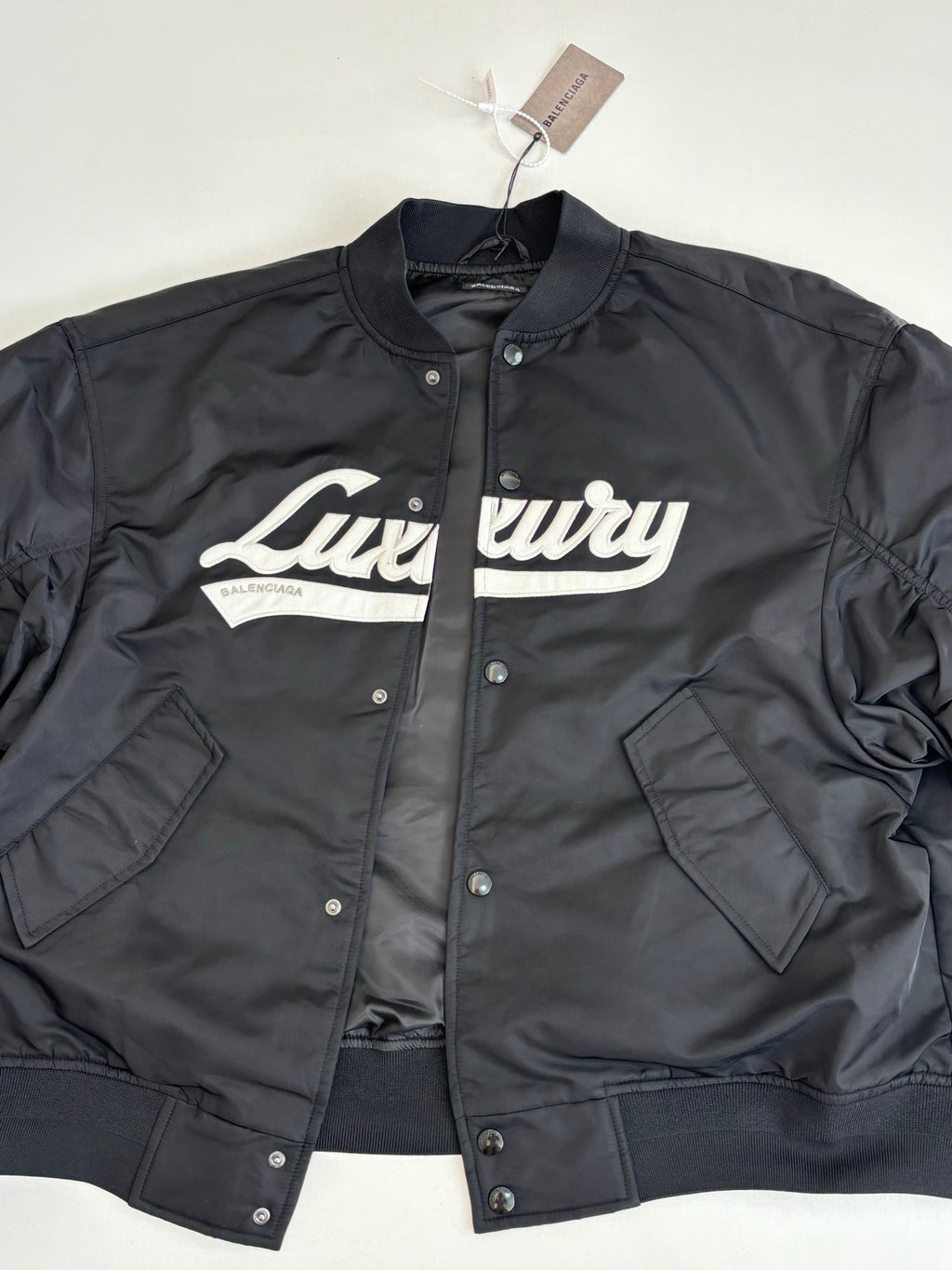 Dark navy bomber jacket front view, Luluvy logo, snap button placket, flap pockets