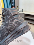 Black high-top sneaker with lace-up front and thick sole, side detail view.