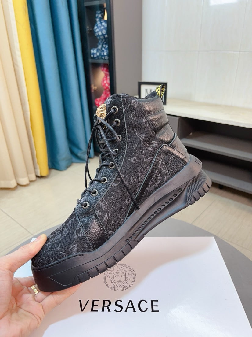 Dark high-top sneakers with lace-up closure and patterned upper, chunky outsole.