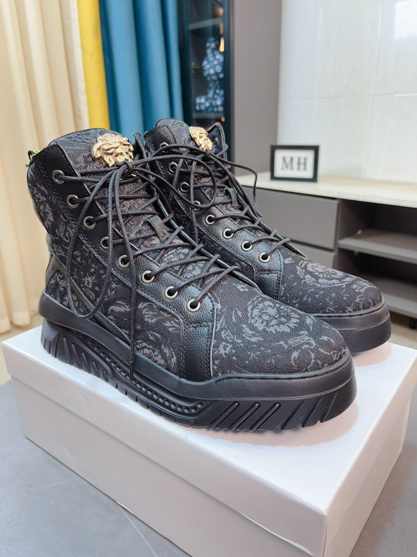 Black high-top lace-up sneakers with ornate pattern and lug sole, angled view.