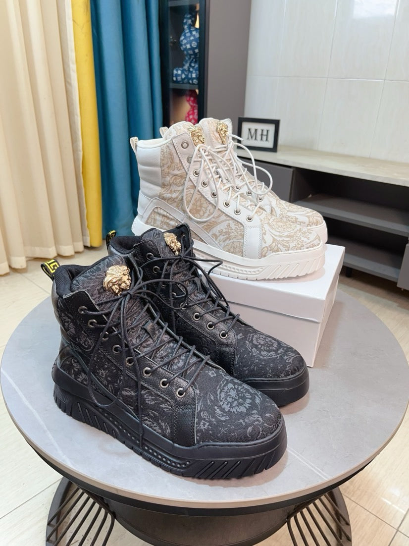 Black high-top sneakers with ornate lace-up pattern and chunky rubber sole.