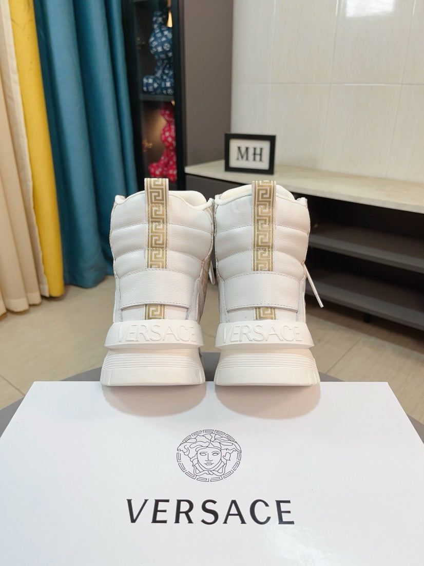 High-top sneakers in white with gold heel trim and low-profile platform tread sole