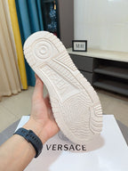High-top sneaker outsole in white with embossed logo and rugged tread pattern