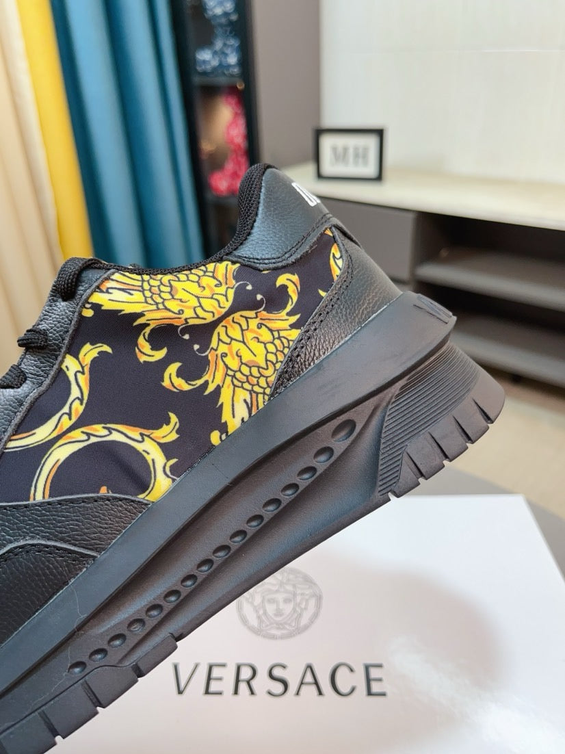 Versace platform sneaker side close-up in dark with gold baroque motif