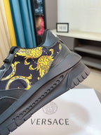 Versace platform sneaker side close-up in dark with gold baroque motif