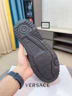 Versace platform sneaker outsole view, dark tread with circular logo detail
