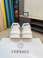 Versace white sneakers from the back with black logo heels and strap tab
