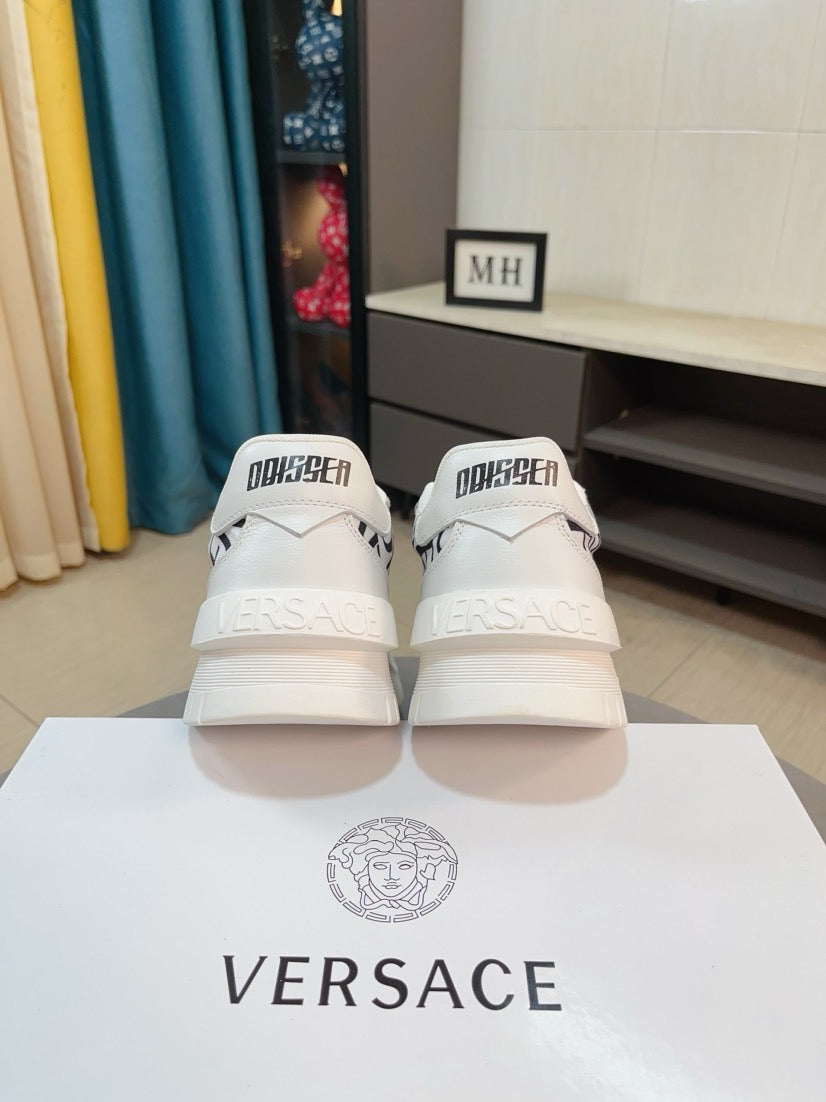 Versace white sneakers from the back with black logo heels and strap tab