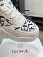 Versace white sneaker close-up with black logo letters and textured sole
