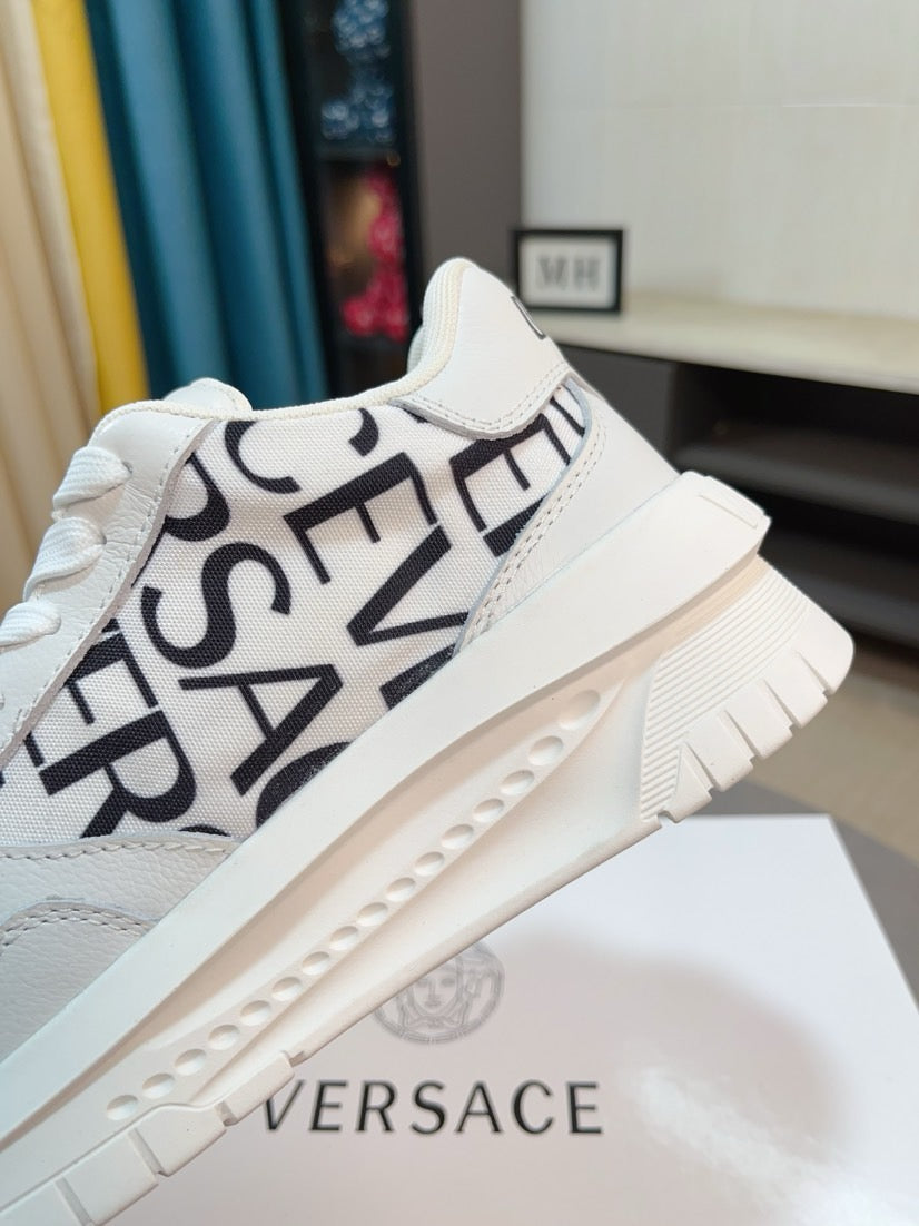 Versace white sneaker with diagonal black logo lettering and beige platform sole