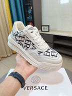 Versace white lace-up sneakers with black logo graphic and thick sole