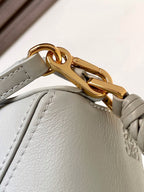 Light blue bag with gold turn-lock clasp and braided strap detail