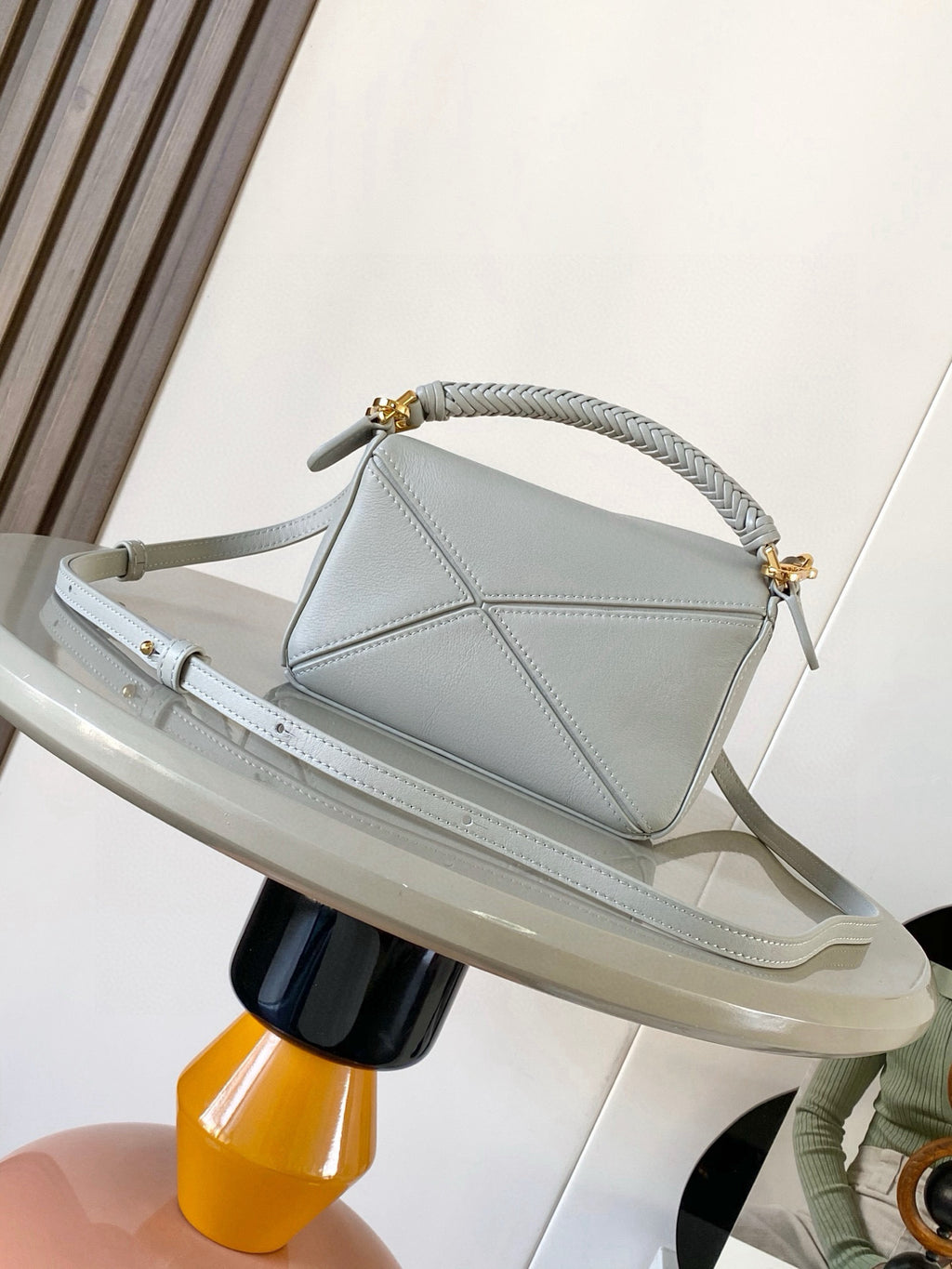 Light blue small handbag with braided top handle and gold accents
