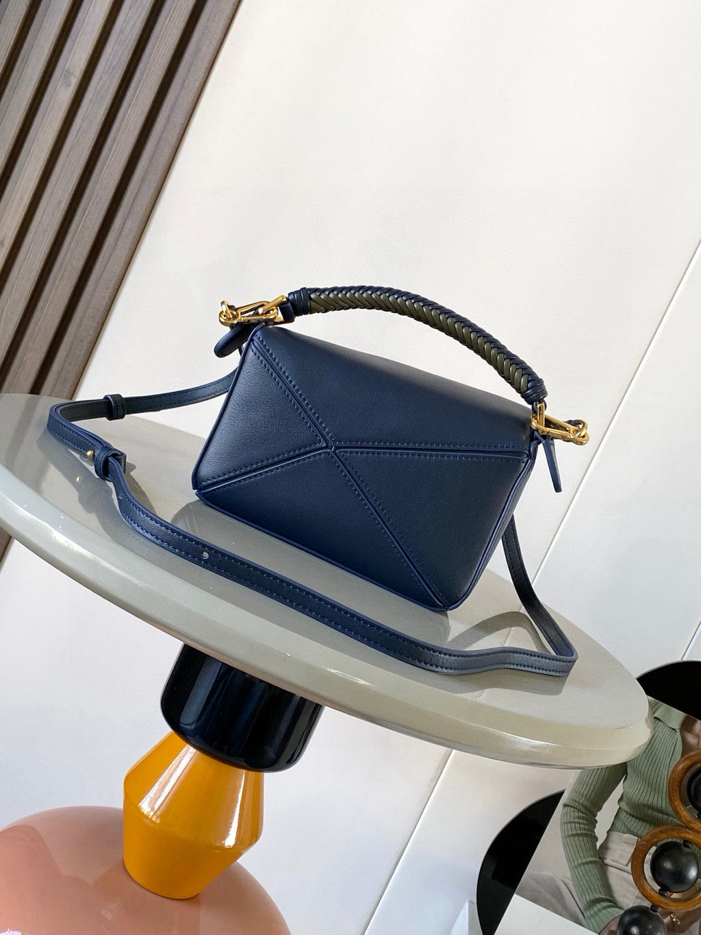 Blue leather crossbody bag with braided handle and gold hardware