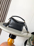Loewe men’s black leather mini shoulder bag with curved handle, crossbody strap, gold hardware.