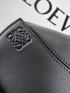 Loewe leather bag panel with embossed clover logo and contrast stitching in dark navy