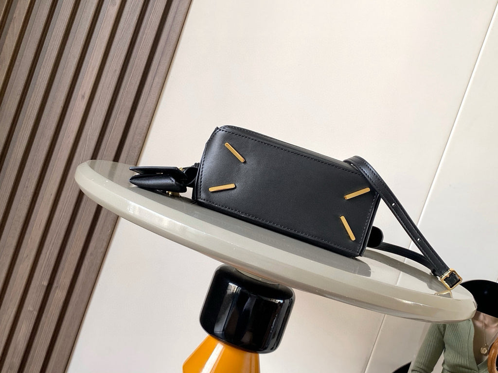 Loewe small leather crossbody bag, dark navy with structured top and gold rivet details