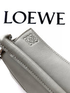 Gray Loewe leather key pouch with embossed logo paw and side strap loop