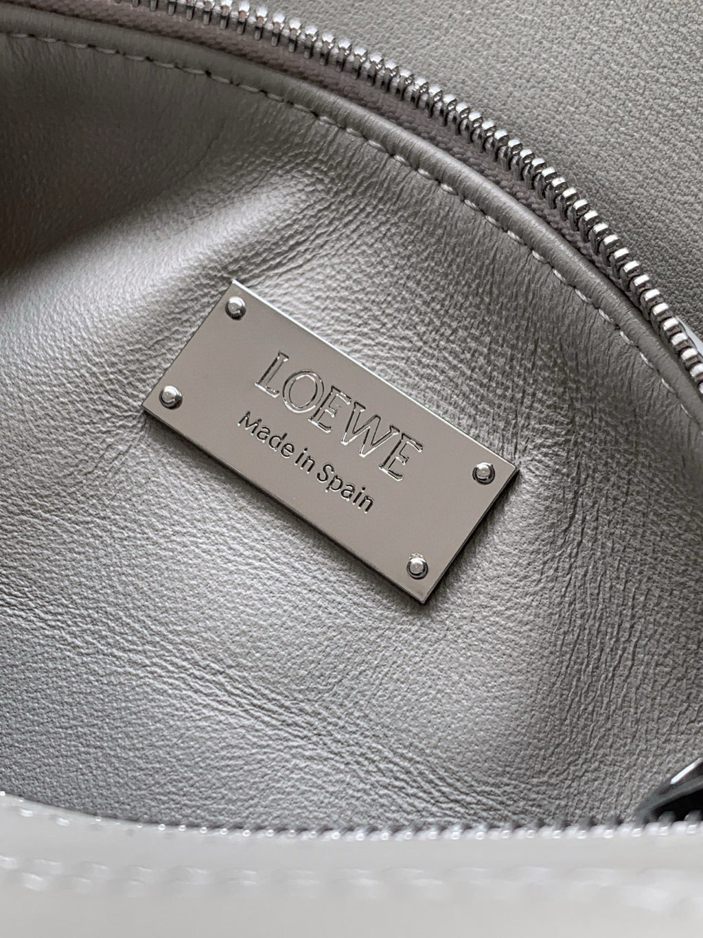 Gray leather bag with metal Loewe 'Made in Spain' plate and zipper trim