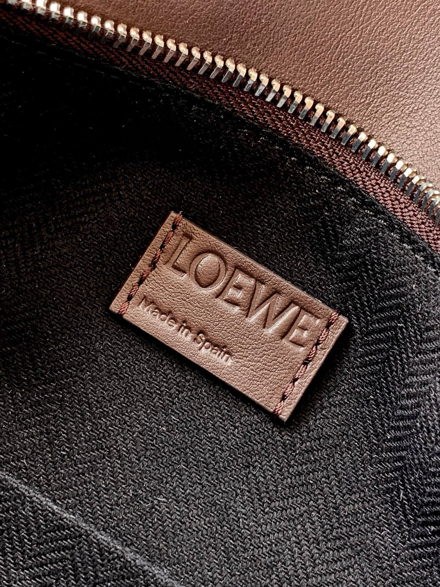 Loewe fabric lining label patch on interior, stitched into dark bag lining