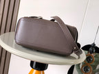 Leather flap crossbody bag with curved top handle and shoulder strap, taupe