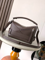 Leather shoulder bag with top handle, front flap, and crossbody strap, taupe