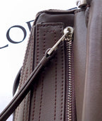 Leather bag front pocket with zipper and silver pull, dark taupe