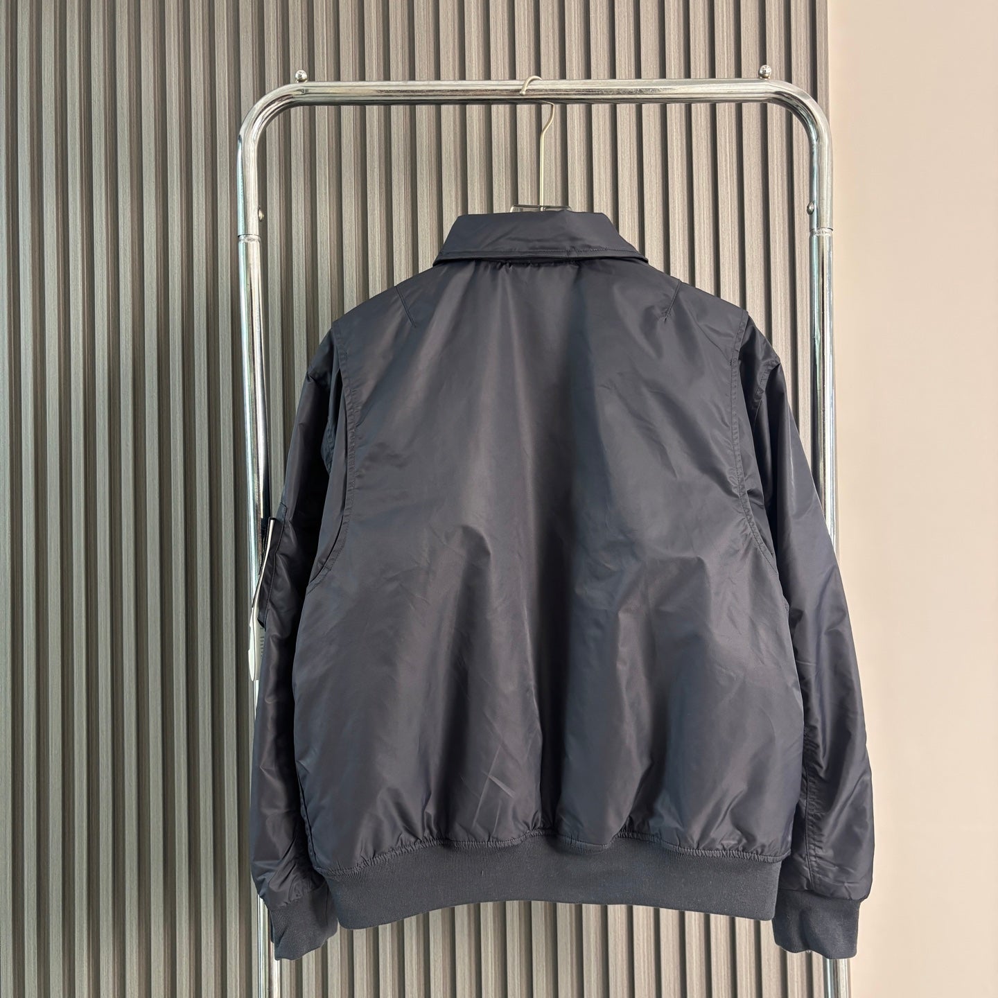 Stone Island bomber jacket back view, dark navy with ribbed collar and cuffs