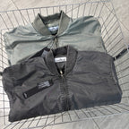 Two Stone Island bomber jackets stacked: dark gray and lighter gray-green, front zips