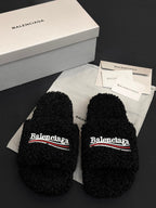 Black fuzzy slide sandals with Balenciaga logo on two straps