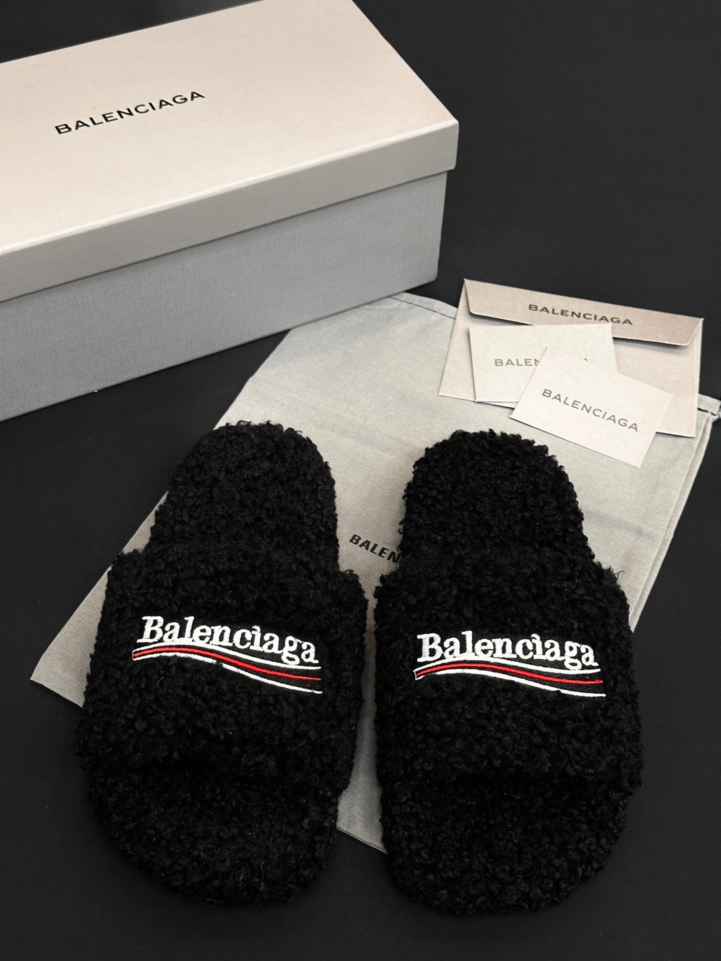 Black fuzzy slide sandals with Balenciaga logo on two straps