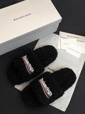 Black fuzzy slide sandals with Balenciaga logo strap