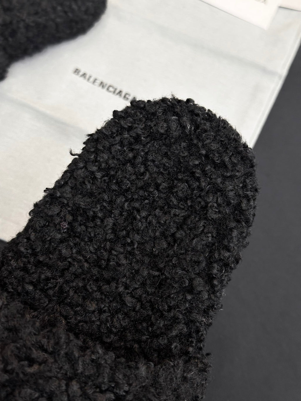 Black fuzzy slide sandal upper with Balenciaga logo patch visible