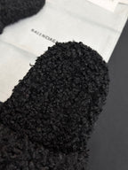 Black fuzzy slide sandal upper with Balenciaga logo patch visible