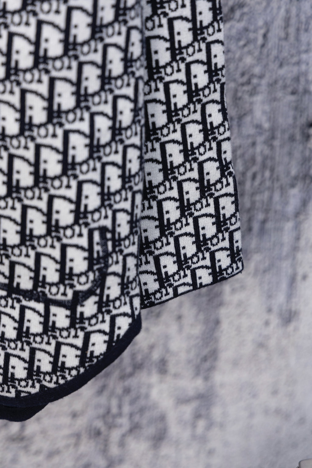 Dior hooded top sleeve with white Dior monogram pattern on navy trim