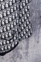 Dior hooded top sleeve with white Dior monogram pattern on navy trim