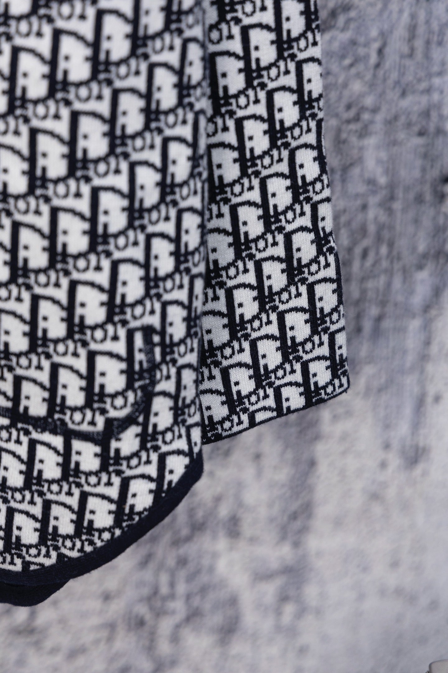 Dior hooded top sleeve with white Dior monogram pattern on navy trim