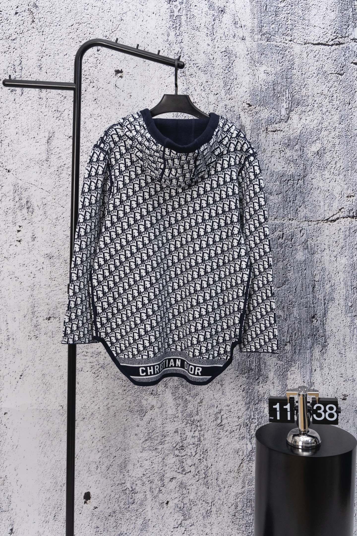 Black-and-white patterned long-sleeve hooded sweatshirt, front zipper view