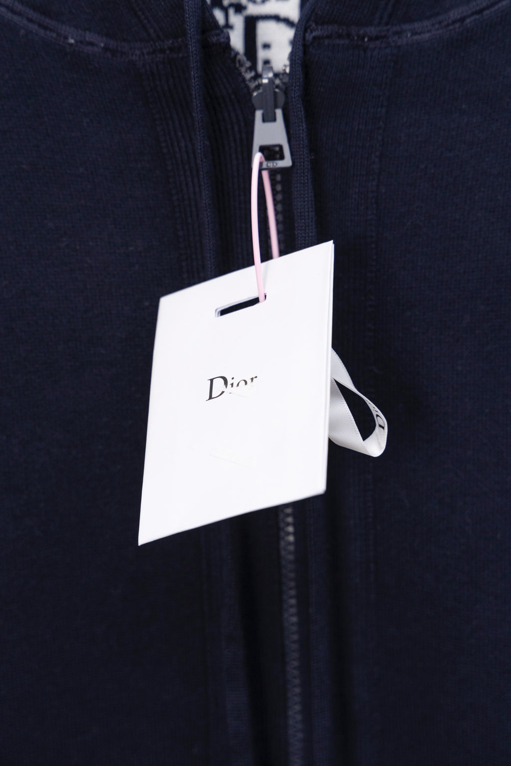 Navy hoodie close-up of front zipper and Dior hang tag
