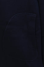 Navy hoodie chest pocket close-up, smooth knit fabric
