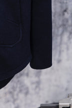 Navy hoodie sleeve and hem detail, side seam close-up