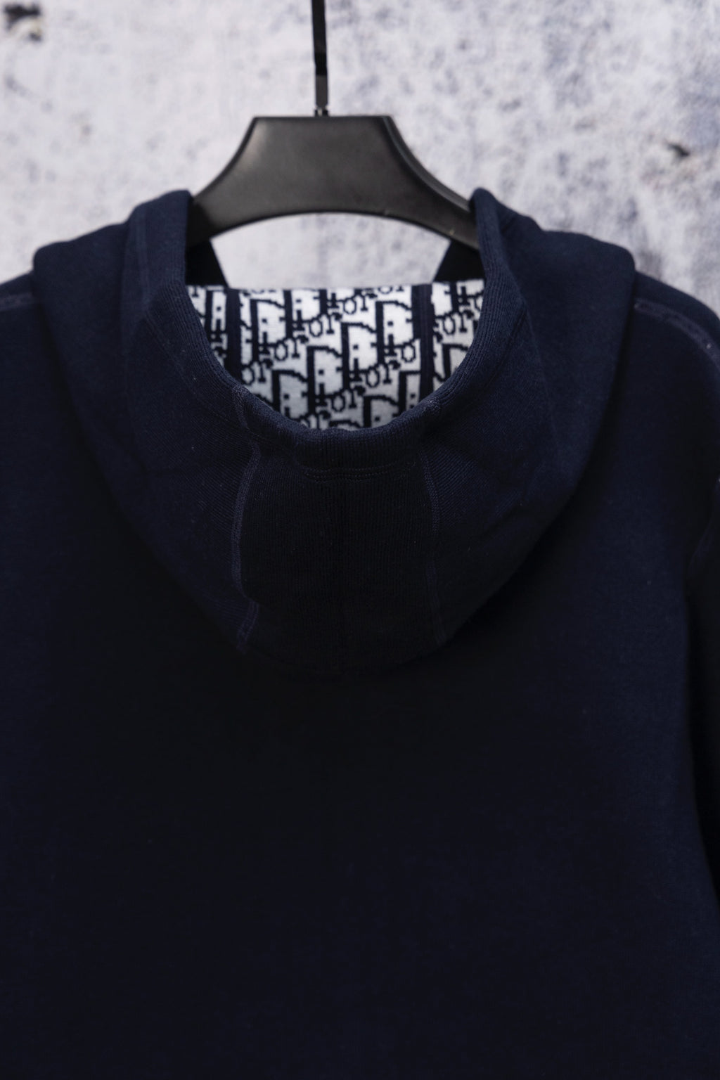 Dior navy hooded top on hanger with patterned inner collar lining