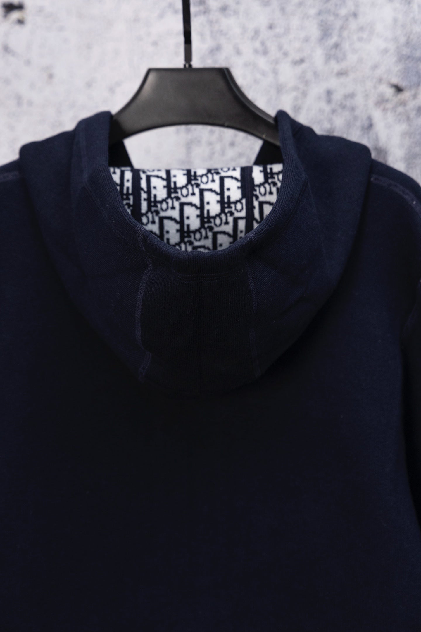 Dior navy hooded top on hanger with patterned inner collar lining